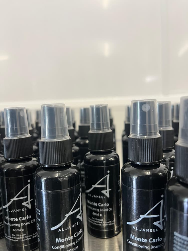 Labelled beard oil bottles lined up after contract labelling.