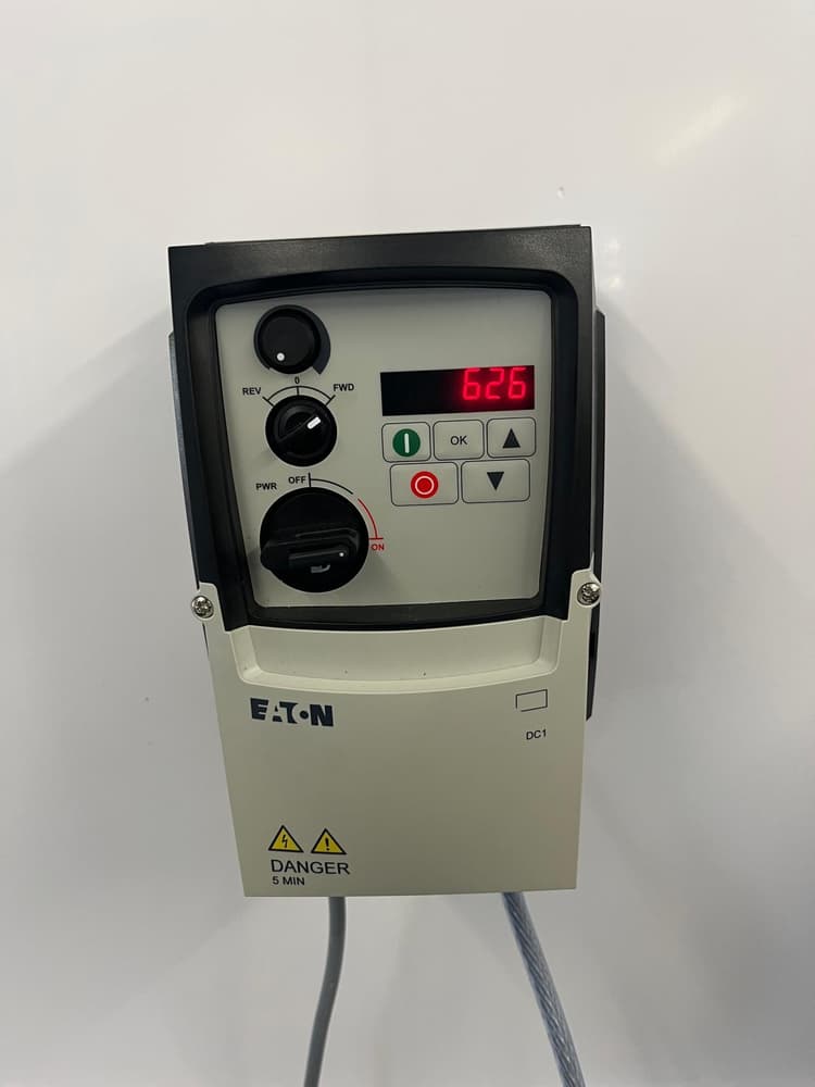 Eaton variable frequency drive controller with red digital display on the plant wall.