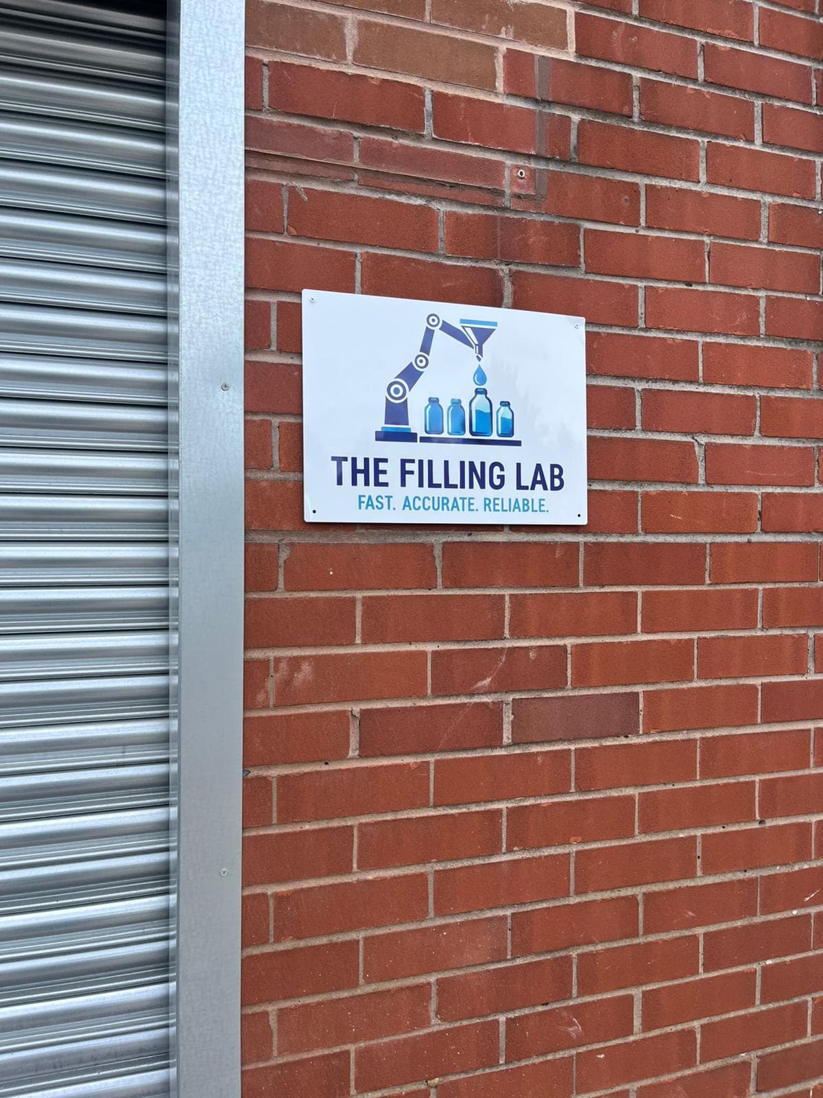 Exterior signage at The Filling Lab facility entrance in Bolton.